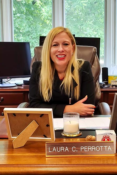 Laura smiling at her desk