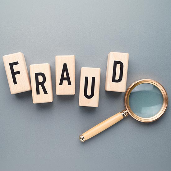 fraud block with magnifying glass