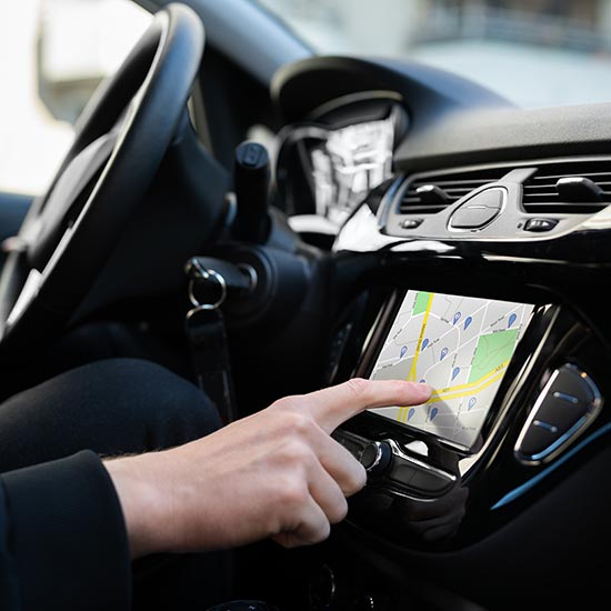 Person working the digital GPS display in a vehicle