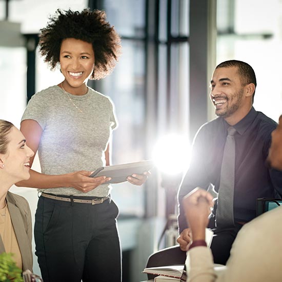 small group of business office workers mingling in a open area